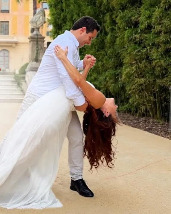 Couple dancing the Waltz of the Flowers choreography in a garden, with a dip